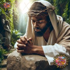 a man with his hands folded on top of a rock