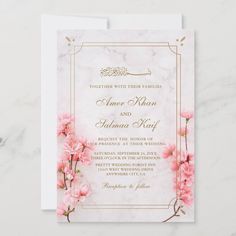 wedding card with pink flowers and gold foil on the front, in white marble background