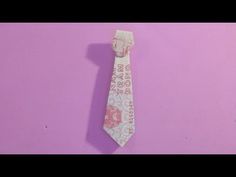 a tie that is on top of a pink surface