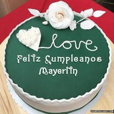 a green cake with white flowers on it that says love happy birthday any name here