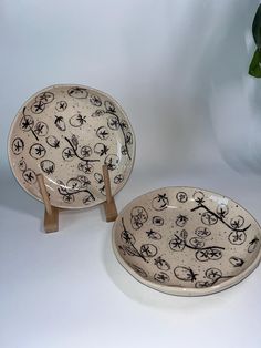 two black and white plates sitting next to each other