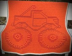 an orange crocheted afghan with the word abc on it