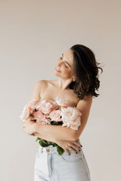 a woman with her arms crossed and flowers in her hair