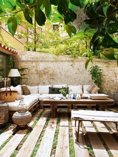 an outdoor living room with wood flooring and furniture