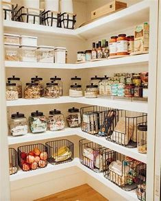 an organized pantry with lots of food in baskets and bins on the bottom shelves