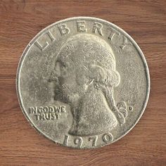 an image of a coin on a wooden surface with the word liberty written in it