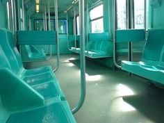 the interior of a subway train with empty seats and no one in it or on the floor