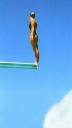 a woman is standing on the edge of a high jump