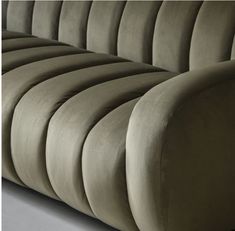 an upholstered couch with curved back and arms