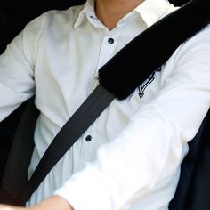 a man sitting in the back seat of a car with his arm wrapped around him