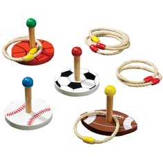 an assortment of wooden toys with balls and ropes on them, including baseballs, basketballs, and rings