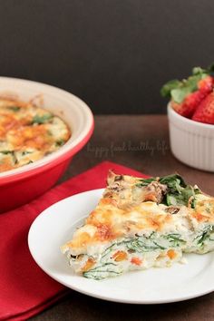 a slice of vegetable lasagna on a plate with strawberries in the background