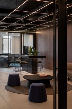 an office with black tables and stools