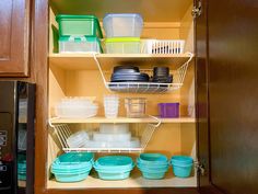 an open cupboard filled with dishes and containers