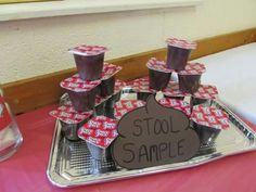 a tray that has some cups on it with the words stool sample written on it