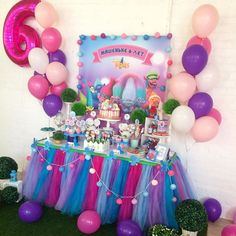 a birthday party with balloons, cake and decorations