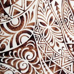 an intricately designed piece of paper with brown and white designs