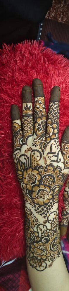 a woman's hand with henna on it