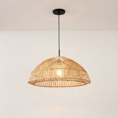 a light fixture hanging from the ceiling in a room with white walls and flooring