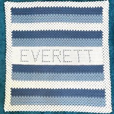 a crocheted afghan with the word'love'written in white and blue