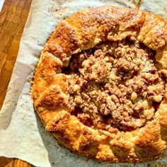 an apple crumb pie on top of parchment paper