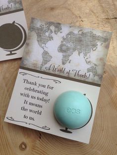 a blue ball sitting on top of a wooden table next to a note with the words thank you for celebrating