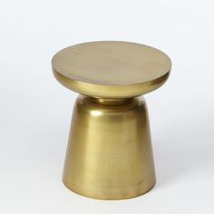 a gold colored metal object on a white background