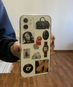 a person holding up an iphone case with many different things on it in their hands