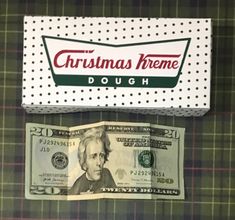 a dollar bill sitting next to a christmas theme doughnut