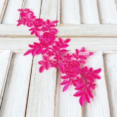 pink flowers on white wooden planks