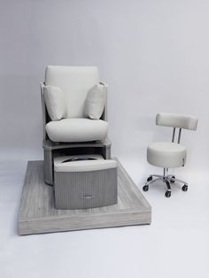 an office chair and footstool are on display