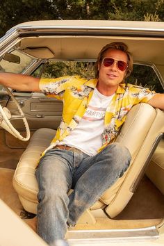 a man sitting in the driver's seat of a car