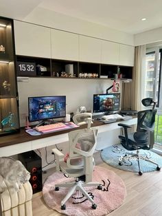 a home office with desk, chair and computer on top of a rug in front of a window