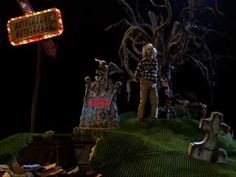 a creepy halloween scene with tombstones and a sign