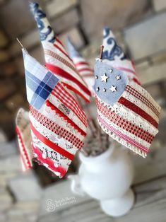 three american flags are placed in a vase