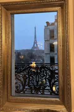 the eiffel tower is seen through a window