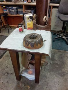 a donut sitting on top of a table covered in wax paper