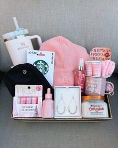 the contents of a woman's purse sitting on a couch next to a coffee cup