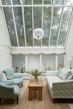 a living room filled with furniture and windows