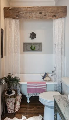 a bathroom with a tub, toilet and sink in it's centerpieces