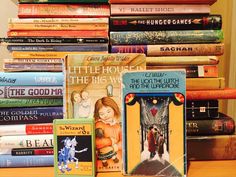 a pile of books sitting on top of a wooden table