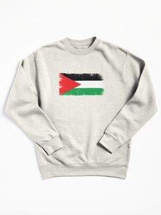 a white sweatshirt with the flag of jordan painted in red, green and black on it