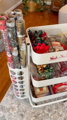 three white containers filled with christmas items on top of a counter next to a wooden floor