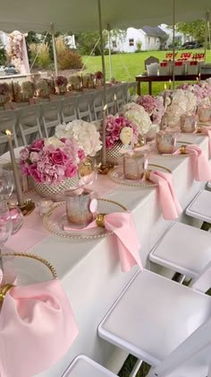 the tables are covered with pink and white flowers