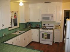 the kitchen is clean and ready for us to use it's white cabinetry