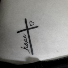 a cross with the word hope written in cursive writing on its lower back