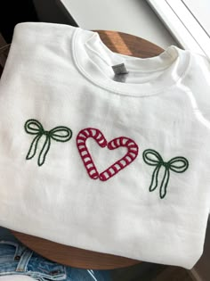 a white shirt with a candy cane heart on it