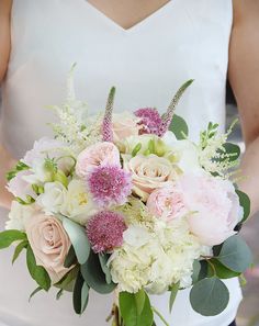 a bridal bouquet with pink and white flowers