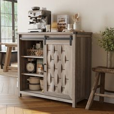 a wooden cabinet sitting on top of a hard wood floor next to a table and chair