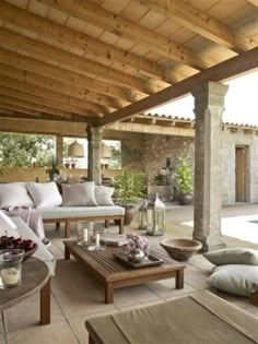 an outdoor living area with couches and tables